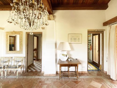a dining room with a chandelier and a table at Villa Smeralda in Olbia