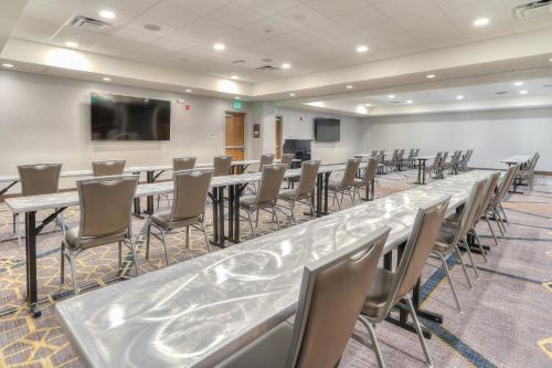 a conference room with a long table and chairs at Holiday Inn & Suites Pigeon Forge Convention Center by IHG in Pigeon Forge