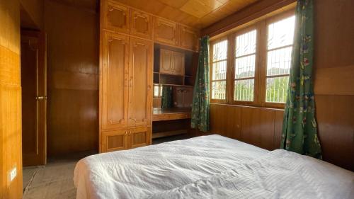 a bedroom with a bed and a window at THE WILLOW HOUSE in Leh
