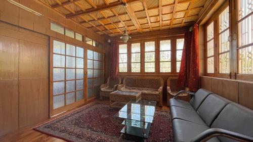 a living room with a couch and a table at THE WILLOW HOUSE in Leh