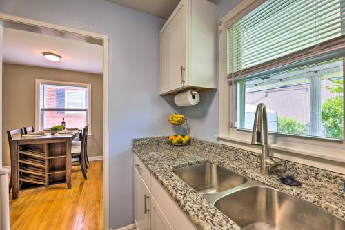 a kitchen with a sink and a table and a window at Charming Charleston Home with Yard and Fire Pit! in Charleston