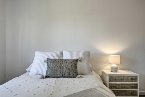 a bedroom with a bed with a pillow and a nightstand at Close to Parks and Brews Sunny Grants Pass Apt! in Grants Pass