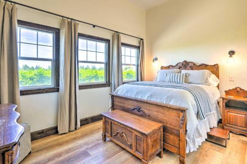 a bedroom with a bed with a wooden dresser and windows at Charming Lodi Retreat Walk to Local Wineries in Lodi