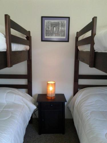 a room with two bunk beds and a candle on a table at DEPARTAMENTOS TERMAS DE CHILLAN in Nevados de Chillan