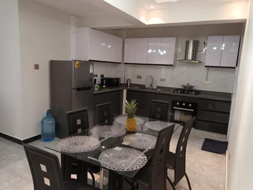 a kitchen with a dining room table with a pineapple on it at Kileleshwa Lavington Shii apartment in Nairobi