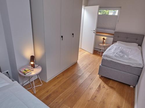 a bedroom with a bed and a table with a candle at Düne 10 in Sankt Peter-Ording