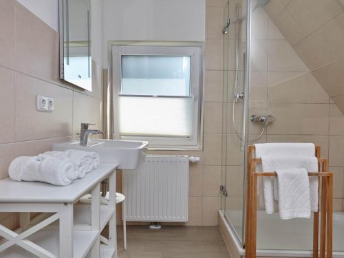 a bathroom with a sink and a shower at Düne 10 in Sankt Peter-Ording