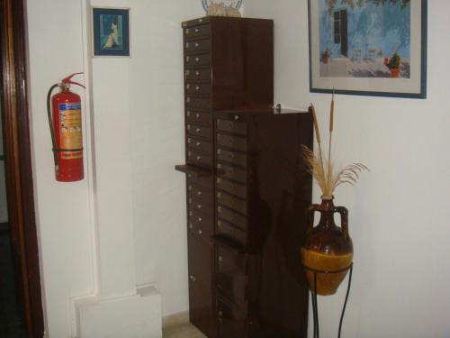 a room with a chest of drawers and a fire extinguisher at Karis Hotel in Kos Town
