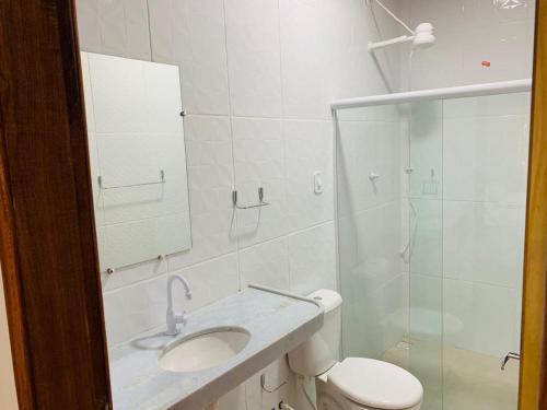 a bathroom with a toilet and a sink and a shower at CASA DE PRAIA CORURIPE - LAGOA DO PAU in Coruripe