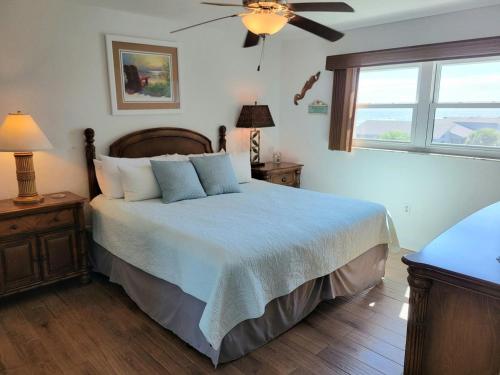 a bedroom with a bed and a ceiling fan at Hacienda del Sol II - 404 in New Smyrna Beach