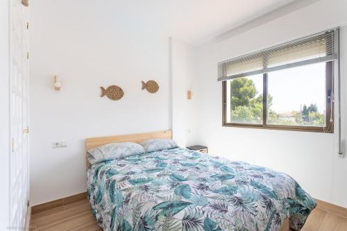 a bedroom with a bed and a window at Albir Beach in Albir