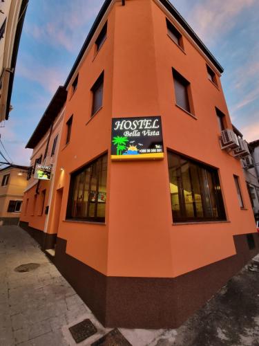 a building with a sign on the side of it at Hostel BellaVista in Koper