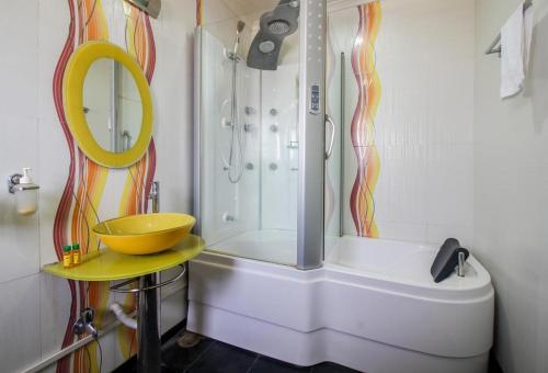 a bathroom with a shower with a sink and a tub at PANCHVATI RESIDENCY ANDHERI WEST in Mumbai