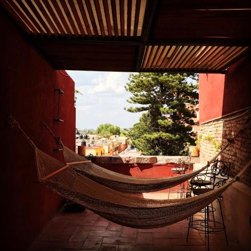 a hammock hanging from a wall in a building at Hotel Rinconada in San Miguel de Allende