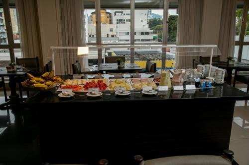 a buffet of food on a table in a hotel room at Plaza Blumenau Hotel in Blumenau
