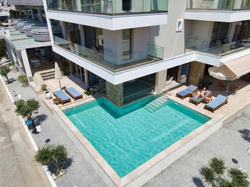 an aerial view of a building with a swimming pool at Hotel Evilion Sea And Sun in Nei Poroi