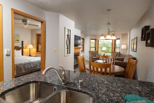 a kitchen with a sink and a living room at Newport Resort in Egg Harbor