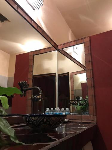 a bathroom with a sink with a mirror at Hotel Rinconada in San Miguel de Allende