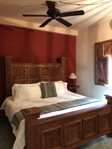 a bedroom with a bed with a ceiling fan at Hotel Rinconada in San Miguel de Allende