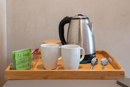 a tray with a coffee pot and cups on it at Suites at TreeTops Tulum in Tulum