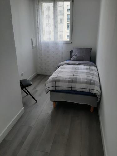 a bedroom with a bed and a window at Appartement cosy de centre ville in Charenton-le-Pont