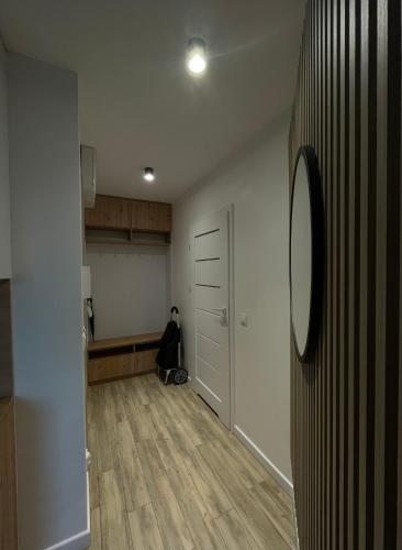 an empty room with a hallway with a person sitting on the floor at Apartament Jantar in Jantar