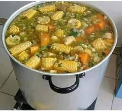 a pot of soup with corn and vegetables in it at casa blanca in Restrepo