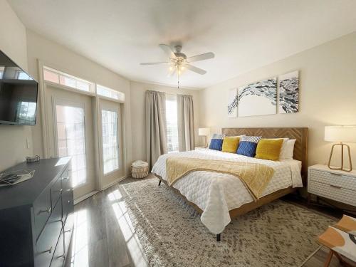 a bedroom with a bed with yellow and blue pillows at Seaside at Anastasia C101 in St. Augustine