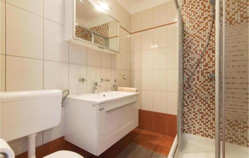 een badkamer met een toilet, een wastafel en een douche bij I & M Guest House in Banjole