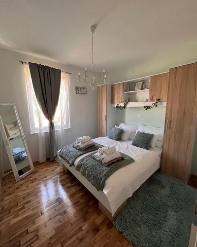 a bedroom with a large bed with two towels on it at Holiday Home Calma in Imotski