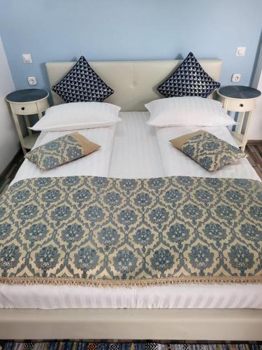 a bed with white sheets and pillows on it at Amaraz Center in Sibiu