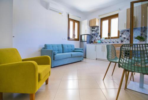 a living room with a blue couch and chairs at Petite palace in Rethymno Town
