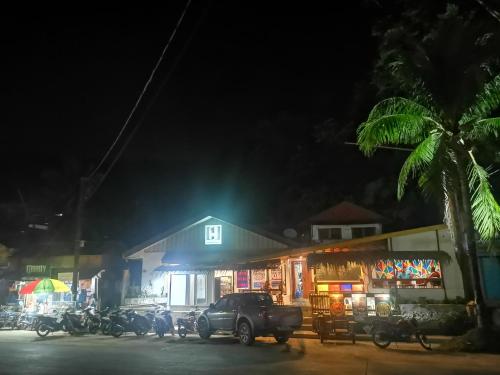 a truck parked in front of a building at night at One Hostel - El Nido in El Nido