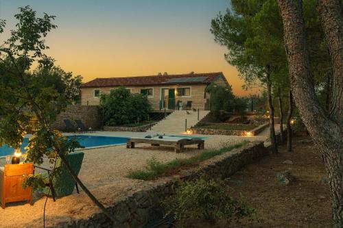 a house with a swimming pool and a house at "The 7th Heaven Garden" Villa in Vodice