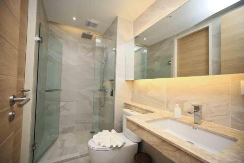 a bathroom with a shower and a toilet and a sink at Apartment in Aonang - great location with pool in Ao Nang Beach