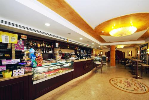 a bar in a restaurant with a lot of alcohol at Fashion Hotel in Valmontone