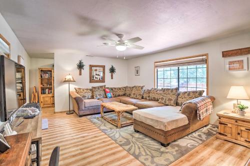 a living room with a couch and a table at Big Bear Cabin with Deck and Hot Tub Near Resorts! in Big Bear Lake