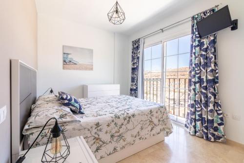 a bedroom with a bed and a large window at Apartamento en Puerto Rico in Mogán