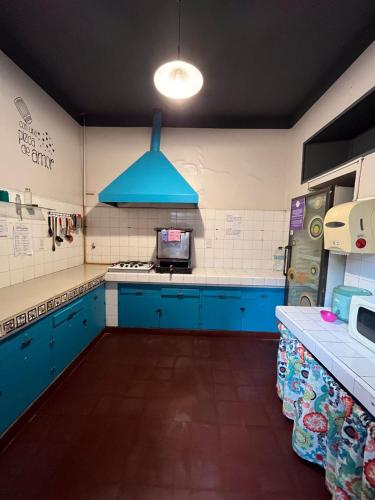 a kitchen with blue cabinets and a blue ceiling at Ferienhaus Hostel Salta in Salta