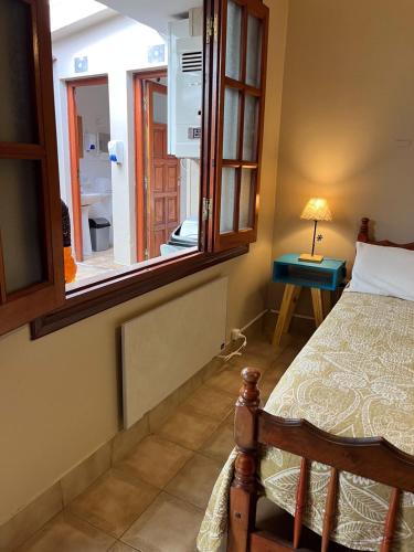 a bedroom with a bed and a large window at Ferienhaus Hostel Salta in Salta