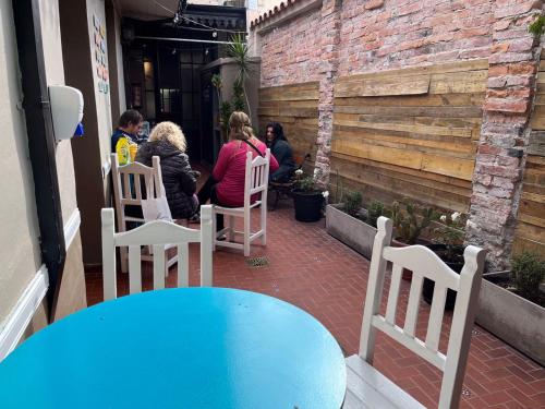 a group of people sitting at a table on a patio at Ferienhaus Hostel Salta in Salta