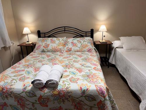 a bedroom with a bed with two towels on it at Ferienhaus Hostel Salta in Salta