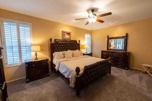 a bedroom with a large bed and a ceiling fan at Mountain View Hide Away with Heated Pool in Phoenix