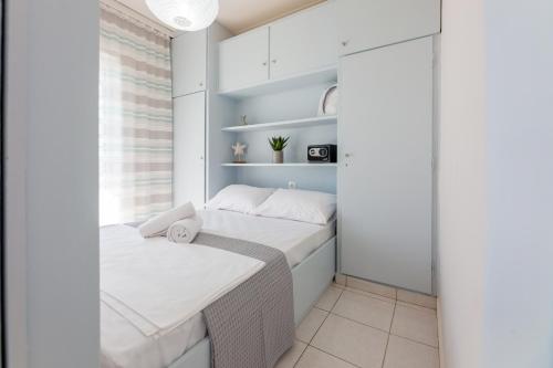 a small bedroom with a bed and a window at Cozy&Quiet Nest in Loutraki