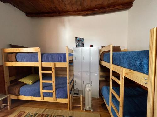 a room with three bunk beds and a radiator at CasaHotel Laguna Jauja Airport in Jauja