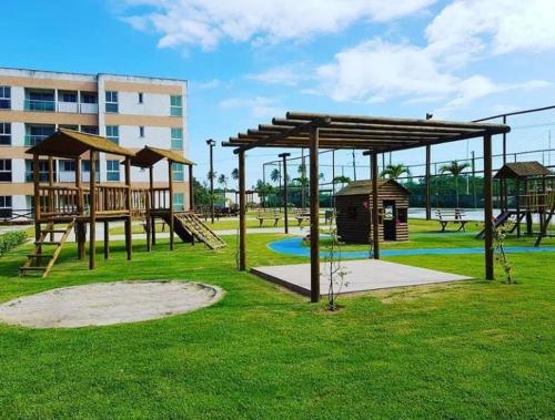 a park with a playground with a slide and swings at MURO ALTO COND CLUBE Bl4 413 in Ipojuca