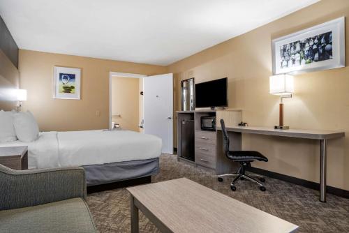 a hotel room with a bed and a desk at Best Western Apalach Inn in Apalachicola