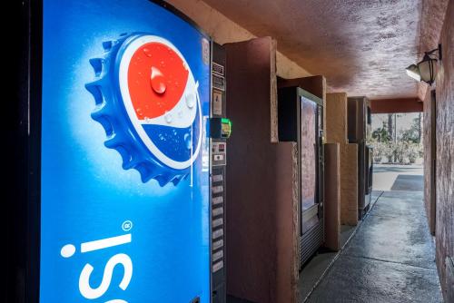 a blue soda machine sitting next to a building at Best Western Apalach Inn in Apalachicola