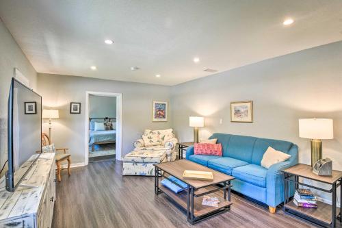 a living room with a blue couch and a tv at Dog-Friendly Home with Gas Grill - Walk to Rose Bay! in Port Orange