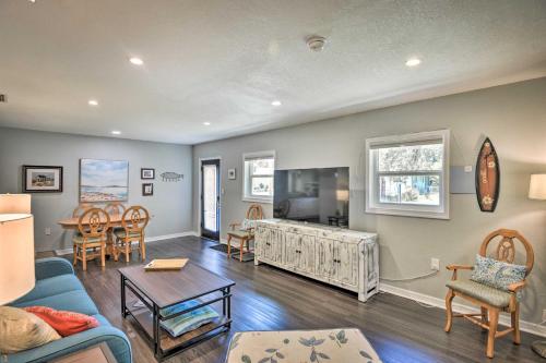 a living room with a blue couch and a tv at Dog-Friendly Home with Gas Grill - Walk to Rose Bay! in Port Orange